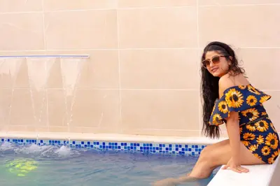 a woman in a bikini sitting in a swimming pool at Hotel Dominican Barcelona in SJM