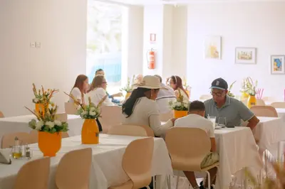 a group of people sitting at tables in a restaurant at Hotel Dominican Barcelona in SJM