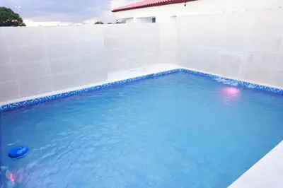 a swimming pool with blue water and white tiles at Hotel Dominican Barcelona in SJM
