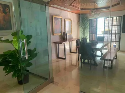 a dining room with a table and a glass wall at Modern Centrical Evaristo Apartment With Tub in Los Prados