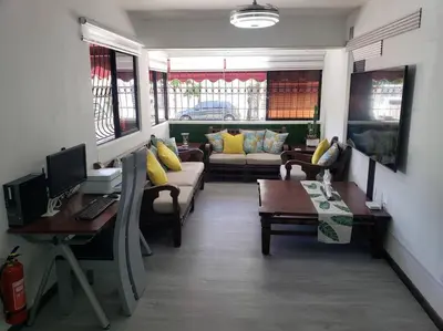 a living room with couches and a desk with a computer at Desiderio in Santo Domingo