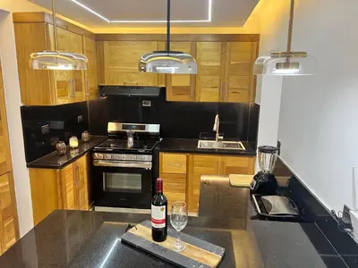 a kitchen with a bottle of wine on a counter at Ático fantástico in Santiago de los Caballeros