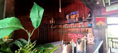 a restaurant with a table with a plant in front of it at Rancho Fernandez in Jarabacoa