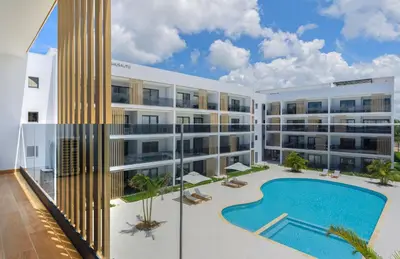 an exterior view of a building with a swimming pool at Beauty condo pool views with gym close to the beach in Punta Cana