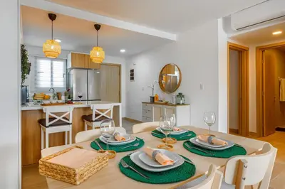 a dining room with a table and chairs and a kitchen at Beauty condo pool views with gym close to the beach in Punta Cana