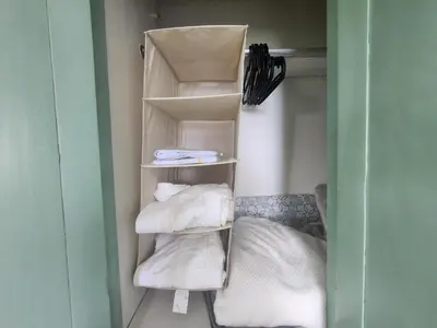 a room with a stack of towels and a bed at Penthouse Apartment with Bay and Mountain Views, Rooftop BBQ, AC, Fast WiFi, Near Saladilla Beach, Barahona in Santa Cruz de Barahona