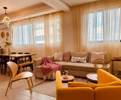 a living room with a couch and a dining room at Condo hotel rialto Recidences in Santiago de los Caballeros