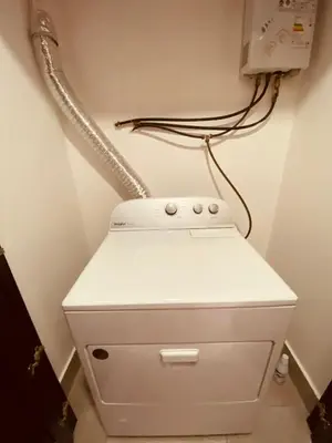 a phone sitting on top of a toilet in a room at Condo hotel rialto Recidences in Santiago de los Caballeros