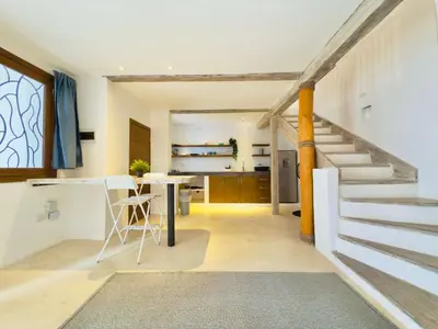 a kitchen and living room with a staircase and a table at Soul Dream Bonita in Las Terrenas
