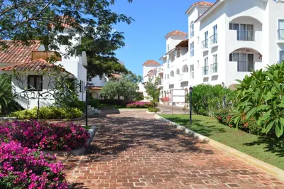 a brick walkway in front of a building at Apartment in Cadaques Caribe in Bayahibe