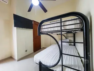 a room with two bunk beds and a ceiling fan at Charming Colonial Santo Domingo in Santo Domingo