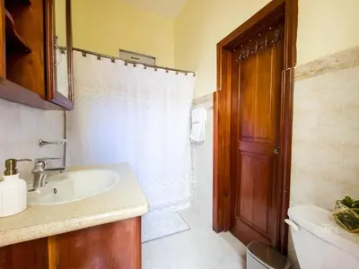 a bathroom with a sink and a toilet and a shower at Charming Colonial Santo Domingo in Santo Domingo