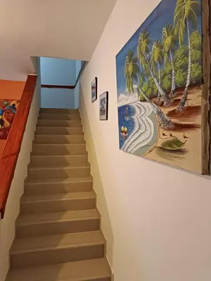 a staircase in a house with a painting on the wall at TropicalHouse in Punta Cana