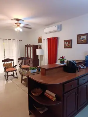 a living room with a desk and a table at TropicalHouse in Punta Cana