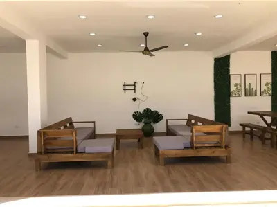 a living room with three chairs and a ceiling fan at Exclusive Paradise Palms Villa in Sosúa