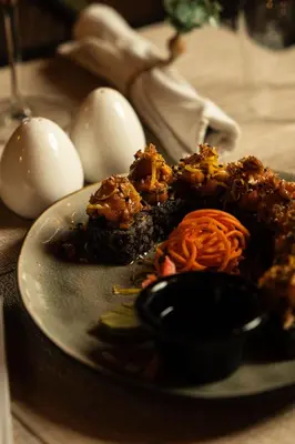 a plate of food with eggs on a table at Empyrean Art Deco in Santo Domingo