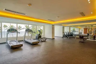 a gym with several treadmills and exercise bikes at Aquarella Sunset Caribbean Beachfront Gataway in La Puntica de Juan Dolio