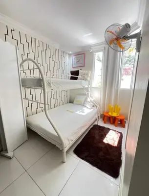 a room with two bunk beds and a rug at Hotel1325 in Baní