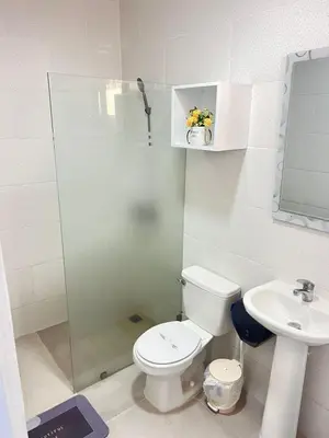 a bathroom with a toilet and a sink and a shower at Hotel1325 in Baní