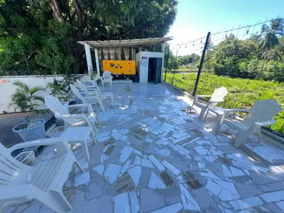a group of white chairs sitting on a patio at Hotel1325 in Baní
