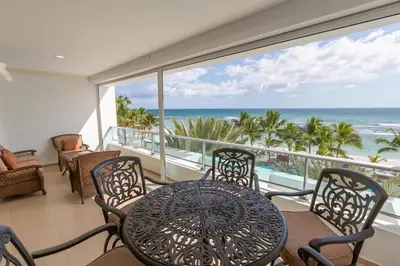 a balcony with a table and chairs and the ocean at Huge Lux 3br Beachfront Condo Wifi Fast in Paraíso