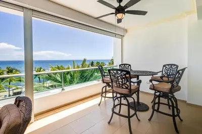 a balcony with a table and chairs and a view of the ocean at Huge Lux 3br Beachfront Condo Wifi Fast in Paraíso