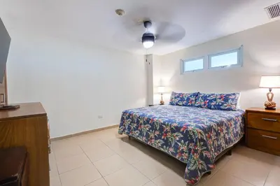 a bedroom with a bed and a ceiling fan at Huge Lux 3br Beachfront Condo Wifi Fast in Paraíso
