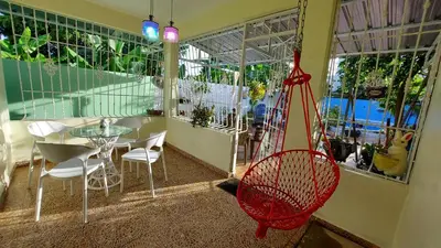 a room with a hammock and a table and chairs at Increible Casa Con Piscina! in Los Frailes