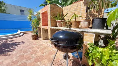 a grill sitting on a patio with potted plants at Increible Casa Con Piscina! in Los Frailes