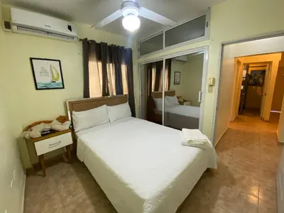 a bedroom with a large white bed and a room with a bed sqor at Increible Casa Con Piscina! in Los Frailes