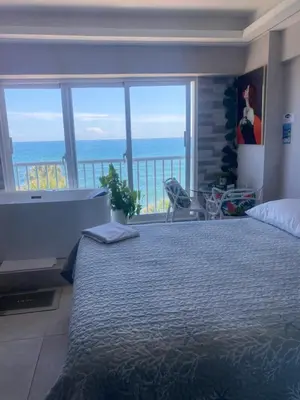 a bedroom with a bed with a view of the ocean at Mar & Relax in Santo Domingo