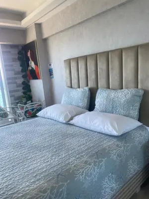 a bedroom with a large bed with white pillows at Mar & Relax in Santo Domingo