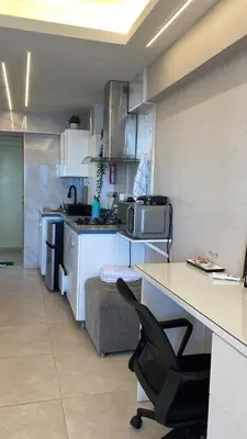 a kitchen with a counter and a desk in a room at Mar & Relax in Santo Domingo