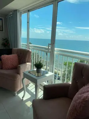 a living room with a view of the ocean at Hermoso Aparta- Estudio Frente al Mar in Santo Domingo