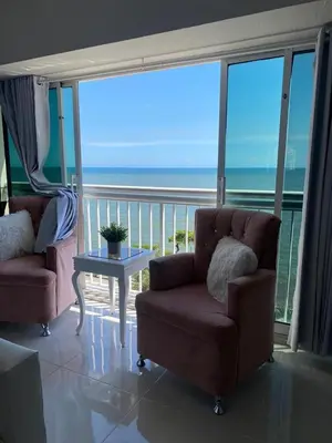 a living room with a couch and a table and the ocean at Hermoso Aparta- Estudio Frente al Mar in Santo Domingo