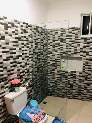 a bathroom with a toilet and a glass shower at Apartamento Acogedor in San Felipe de Puerto Plata