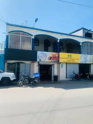 a building with motorcycles parked in front of it at Apartamento Mariela 2 in San Felipe de Puerto Plata