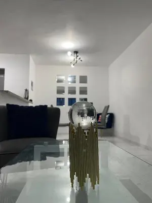 a living room with a glass table with a clock on it at Disfruta, te lo mereces in La Romana