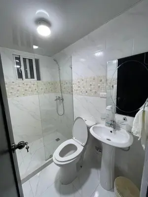 a white bathroom with a toilet and a sink at Disfruta, te lo mereces in La Romana