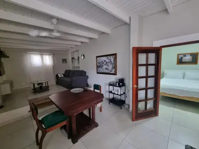 a living room with a table and a bed at Apartamento Estudio Puerto Plata in San Felipe de Puerto Plata