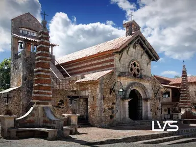 an old stone church with a cross in front of it at Zen Oasis Villa at Casa de Campo in La Romana