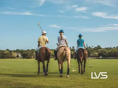 three people on horses playing a game of polo at Zen Oasis Villa at Casa de Campo in La Romana