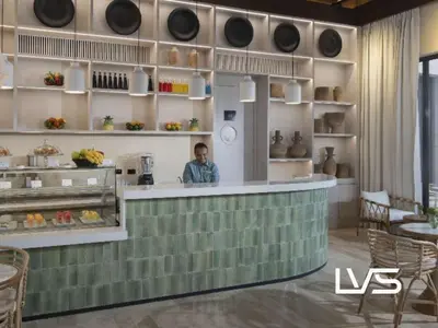 a man sitting at a counter in a restaurant at Zen Oasis Villa at Casa de Campo in La Romana