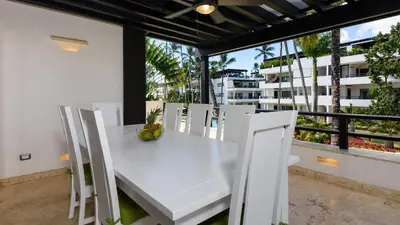a white table and chairs on a balcony at Aligio Apart-hotel & Spa - Las Terrenas in Las Terrenas