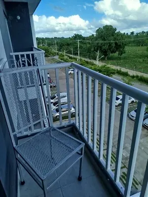 a chair on a porch with a view of a parking lot at Higüey City Home in Higuey