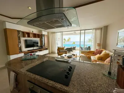 a kitchen and living room with a view of the ocean at Marbella, Juan Dolio, Republica Dominicana in Juan Pedro