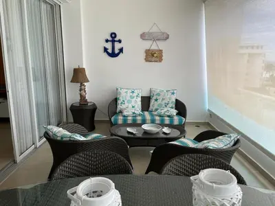a living room with chairs and a coffee table at Marbella, Juan Dolio, Republica Dominicana in Juan Pedro