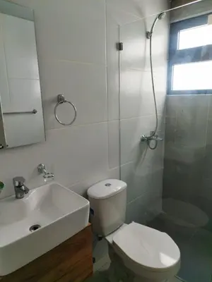 a bathroom with a toilet and a sink and a shower at santiago de los caballeros hipanoamericana in Santiago de los Caballeros