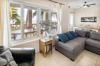 a living room with a couch and a table at Ocean front 2bdrm-2bath at Ocean Point 1 - Kitebeach Cabarete in Cabarete