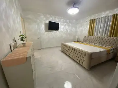a bedroom with a bed and a television in it at 6B Santiago Harmonic Apt Especially For You in Santiago de los Caballeros